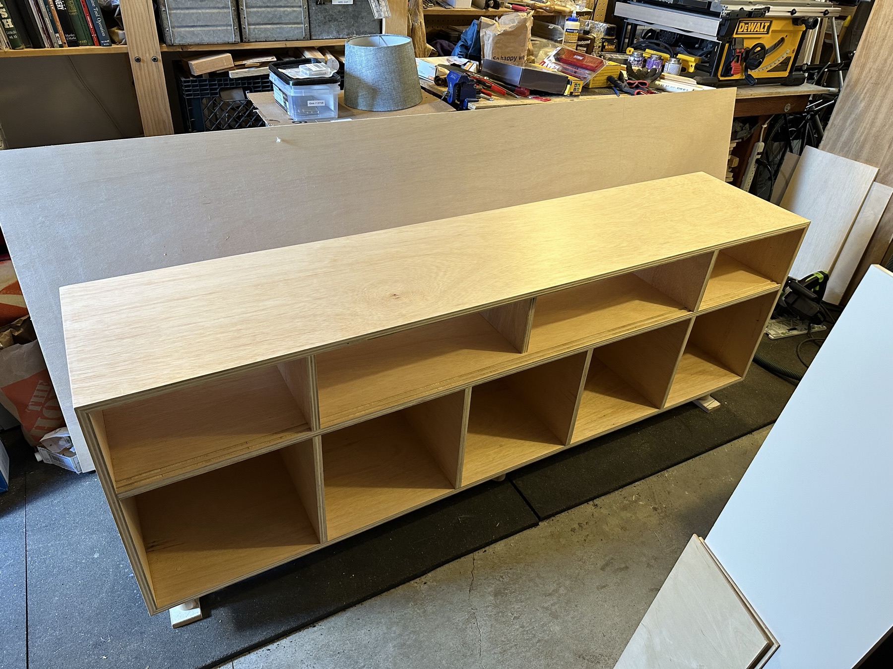 Unfinished plywood cabinet carcass in the workshop, before doors and speakers were added